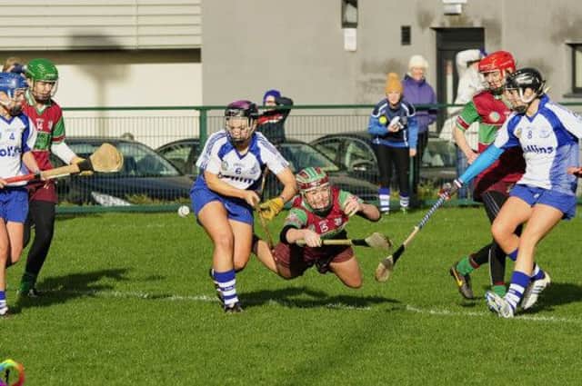 An Eoghan Rua player throws herself into the action.
