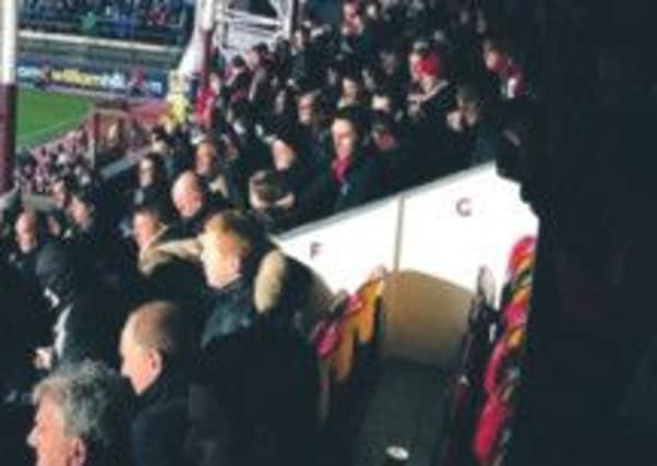 Neil Lennon in the stands at Tynecastle were he was verbally abused and attacked with coins and plastic cups