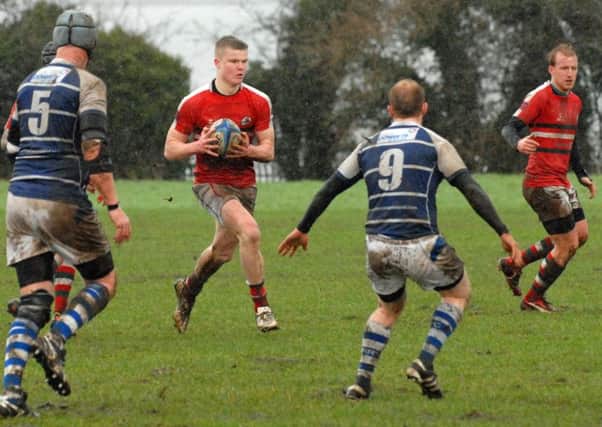 Larne's Jordan Burns assesses his options against Newry RFC at a very wet and windy Glynn. INLT 06-016-PSB