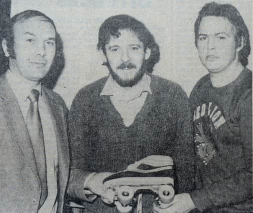 Arnold Cobain (left) of Sport and Leisure, presenting a pair of roller skates to Martin Hawkins,  included is club secretary Ken Montgomery. INCT 06-903-CON