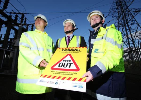 George Ong, NI Water, Roy Beggs MLA and Sam Gibson, NIE at Ballyvallagh substation.  INLT 06-695-CON