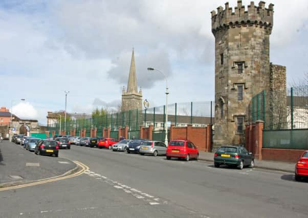 The Bishop Street/Fountain Estate interface. In background is the city's St. Columb's Cathedral, and on right, the remaining Derry jail tower, now used as a museum.