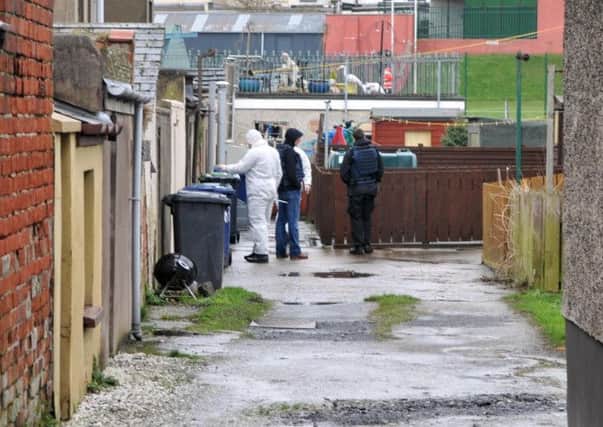 Forensic officers search at the rear of houses in Victoria Street. INLM06-107gc