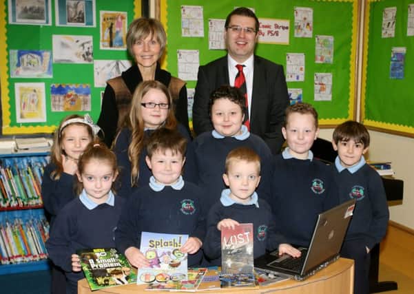 Pupils from Carnaghts PS pictured along with Andrew Dickinson of Wilsons of Rathkenny, who are sponsoring eBooks for the schools new reading initiative. The schools PTA are also providing books for the children. Included is teacher Mrs. Valerie Dawson. INBT06-240AC