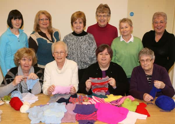 Mary Waldron (President) and Joan Leeman (co-ordinator) of Ballymena Inner Wheel Club are pictured receiving various baby garments made by members of the All Saints Craft Circle. The clothes will go to a childrens hospital in Ethiopia. INBT06-200AC