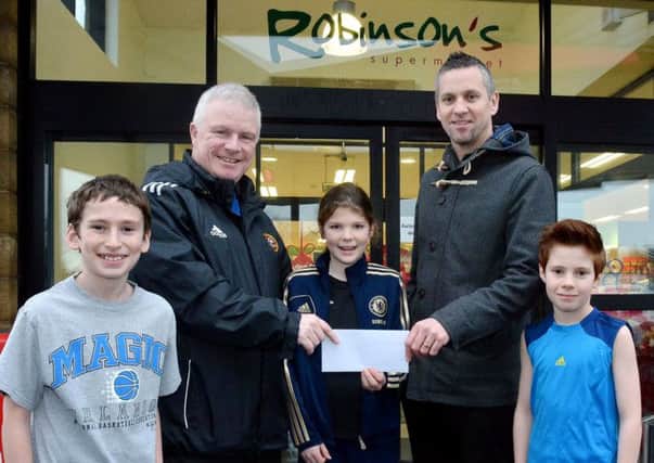 Gary Olphart, Manager of Robinson Costcutters,  presents Billy OFlaherty, with sponsorship for the Carniny football Development Centre. Included are Carniny Youth players Joel Telford, Rachael Dennison and Nial Pogue. INBT 07-804H