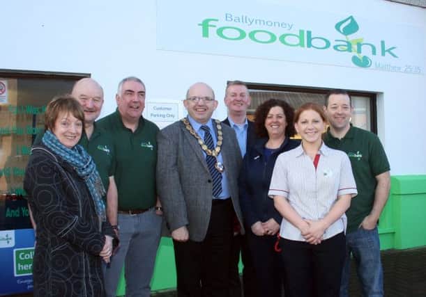 The Mayor, Councillor John Finlay, joins volunteers Peter Rollins, Jarlath Heggarty and John McClements along with Cllr. Ian Stevenson, Liz Johnston and Jackie and Hilary from Tesco at the official opening of Ballymoney Foodbank last Friday.INBM07-014 148F