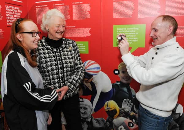 Dad Paul takes the opportunity to get a picture of his two Olympic heroes, his daughter Sammy Jo Sweeney and Dame Mary Peters, at the launch of the Ulster Sports Museum Association Exhibition at the Burnavon Arts & Cultural Centre. INMM0614-131ar.