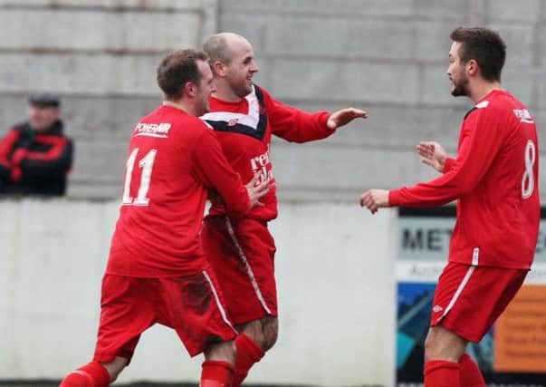 Kyle Agnew (centre) celebrates after opening the scoring for Ballyclare Comrades. Photo: Freddie Parkinson
