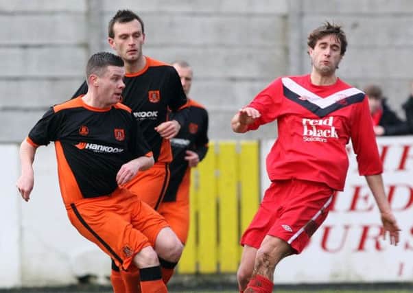 Carrick's Ciaran Donaghy and Ballyclare's Chris Trussell. Photo: Freddie Parkinson