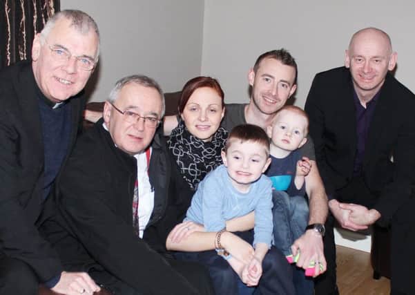 Representatives of the Coleraine Charitable Trust with the Dickey family. From left, Fr Charlie Keaney, Rev Bert Ritchie, Charlene and Neill Dickey with children Oliver and Max and David Rankin. INCR07-136MJ