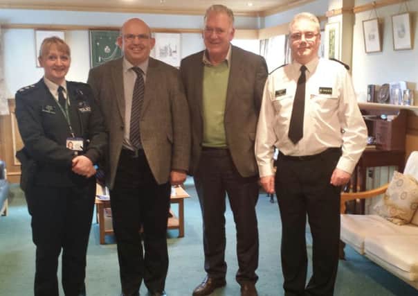 Pictured are Mayor of Ballymoney, DUP Cllr John Finlay, and his party colleague Alderman Bill Kennedy, alongside police officers during the meeting.