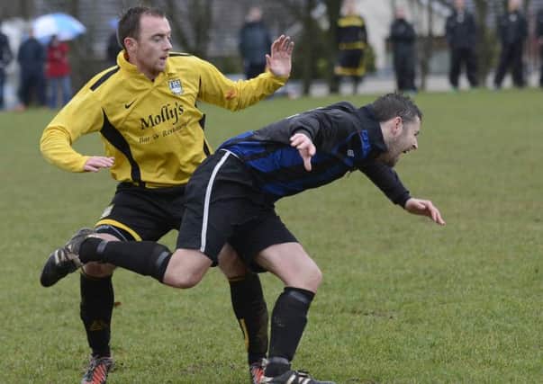 BBOB's Nicky Cooke feels the weight of the challenge from a Lisnarick FC player. INLS0614-157KM