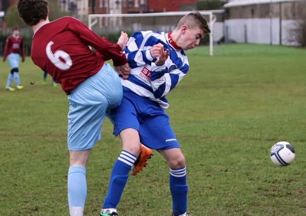 This Institute player clashes with Northends Jordan Savage during their recent match at the Smithfield pitch. INBT07-233AC