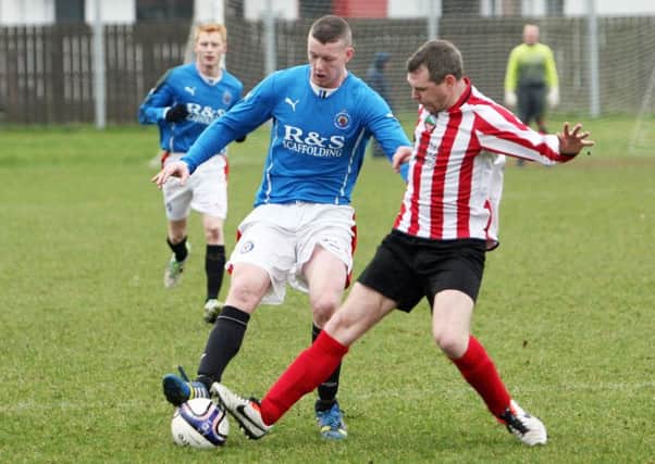 Dean Dunlop of Carniny Rangers gets tackled by a Beann Mhadiaghan player. INBT07-238AC