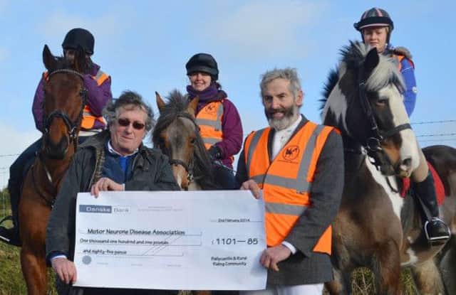 Paddy Traynor, club chair, is pictured handing over the cheque to Stephen Thompson from the Motor Neurone Disease Association, with committee members Marissa McLaughlin, Sonia Serramia Ruiz and Nicole McGinn on horseback. INBM07-14