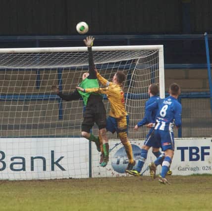 Ryan Harpur impedes Coleraine goalkeeper Eugene Ferry in the build up to Dungannon's third goal, but not according to referee Arnold Hunter.