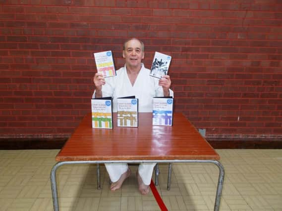 Dan Redmond poses with the new club DVDs