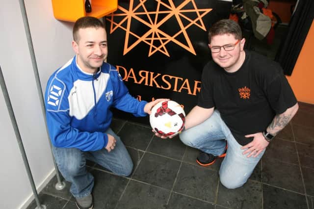 Ryan Duffy of Brook Street FC is presented with a match ball from Clarke McCormick of Dark Star in Coleraine. incr05-124pl