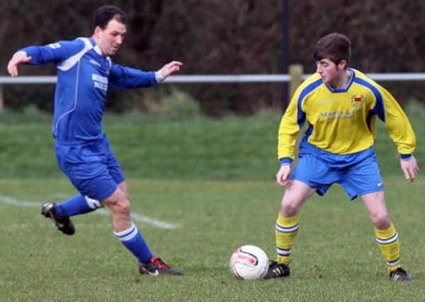 18th Newtownabbey's Neil Campbell Battles for possession against Mossley. INNT 07-015-FP