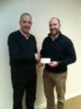 Local Businessman Jonathan Gault presents a cheque for £3260.79 to Richard Spratt CEO of Fields of Life. INBM08-14