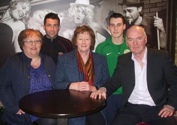 Back row Glentoran player Niall Henderson and Lurgan Celtic player Shane Mc Cabe with front row, members of the Derrytrasna Lourdes Committee Mairead Breen, Mary Austin and Eugene Creaney.