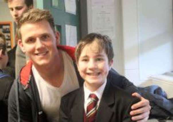 Ulster's Craig Gilroy, pictured with one of the pupils at Ulidia Integrated Colllege.