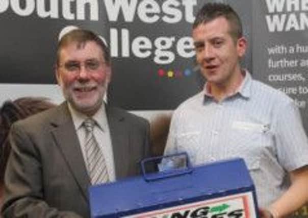 Social Development Minister Nelson McCausland presented with a Going Places toolbox by programme participant Michael Mills at South West College Dungannon.