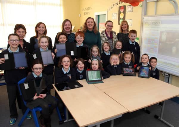 Pupils, staff and PTA members of Carnalridge Primary School with the new ipad's. Included standing right is Jennifer from Espresso. INCR07-140PL