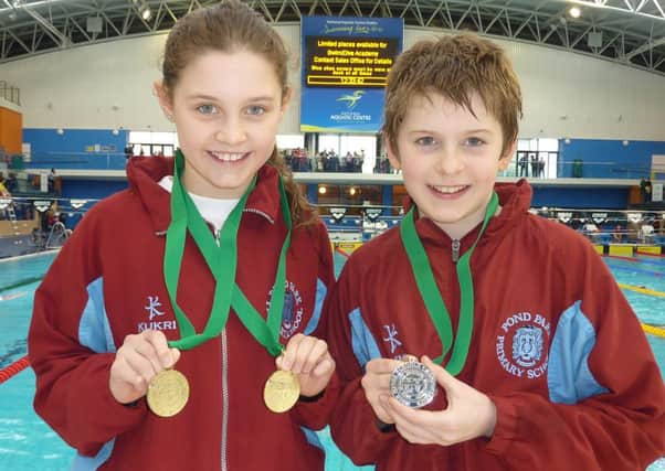 Leah Bethel and Daniel Mulholland with their medals at last weekend's Irish Minor Schools swimming gala.