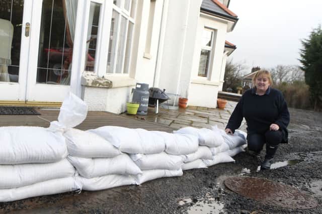 Valerie Watson wit sandbags at her home on Rathlin Road