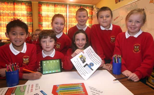 Pupils in Mr Baird's P5 class at Carnmoney Primary School designing posters for Safer Internet Day. INNT 07-085-FP