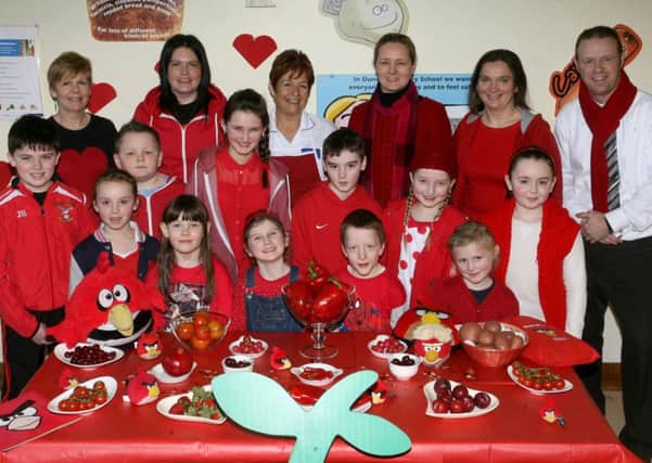 Pupils from Dunclug PS along with staff and members of the school canteen who dressed in red as part of the "Ramp Up The Red Day" raising money for the British Heart Foundation. The event was organised by the school canteen staff. INBT07-218AC