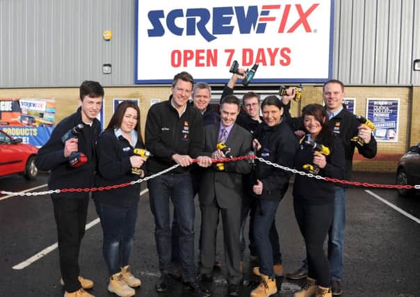 Paul Frew MLA helps the Ballymena Screwfix team open the store.