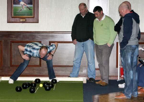 Getting down for a close look at the jack during the Clough Rangers v Ballymena Golf Club bowling match. INBT08-218AC