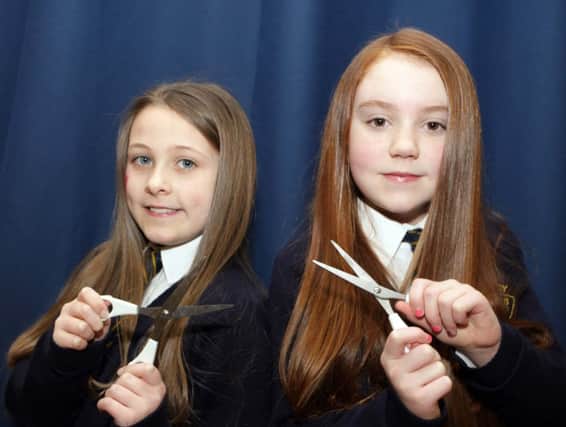 HAIR WE GO. Armoy PS pupils, Chloe McMullan and Emma Elder, pictured before having their hair cut on Friday to raise funds for The Little Princess Trust.INBM8-14 006SC.