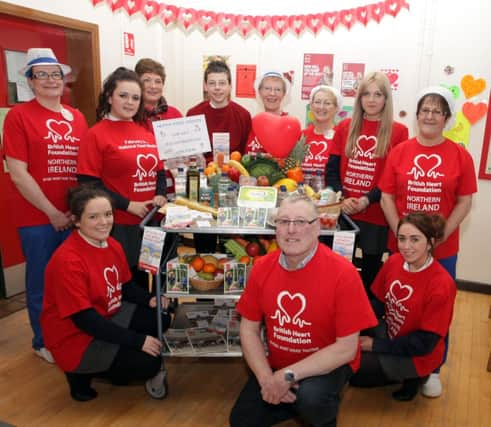 HIGH HEARTS. Pictured in the Canteen at Ballymoney High School along with British Heart Foundation (N.Ireland) Volunteer James Walker are pupils, Canteen Supervisor Helen Paul, Canteen staff and H.E. Teacher Elizabeth Campbell.INBM8-14 004SC.