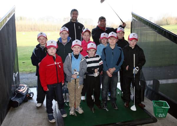 Golf coaches Russ Oliver and Alaister McDiarmid are pictured with some of the children taking part in the Junior Golf Academy at Galgorm Castle Golf Club. INBT08-265AC