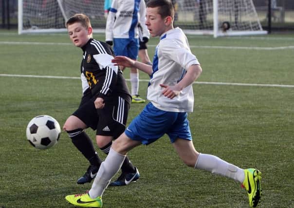 Carniny U-14 player David Leetch stops his St. Andrews opponent from crossing to a team mate. INBT08-291AC