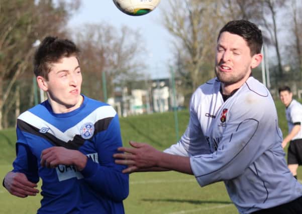 Eoin Gillan (left) in action for Ballymoney United versus Queen's University in the Intermediate Cup.