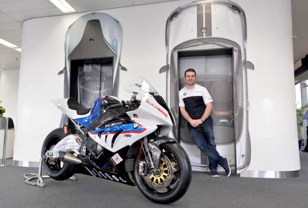 PACEMAKER, BELFAST, 4/2/2014: Michael Dunlop pictured with the BMW S1000RR Superbike that he will race in 2014.  The 24 year old seven time TT winner visited BMW UK's headquarters at Bracknell where he saw the Superbike and Superstock versions of the German machine that he will ride at the North West 200, TT, Ulster Grand Prix and Macau Grand Prix.
PICTURE BY STEPHEN DAVISON