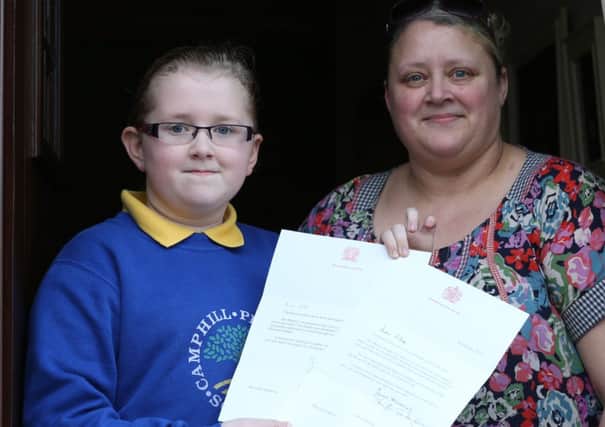 Ellie Marklew and her mum Tracey with the letters Ellie received from Her Majesty Queen Elizabeth. INBT 08-104JC