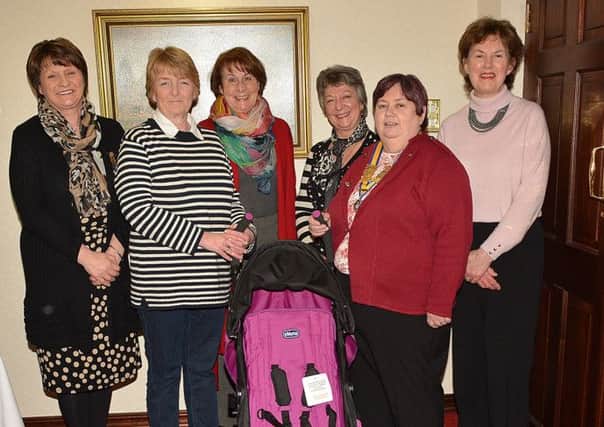 President of Ballymena Inner Wheel Mary Waldron and club members Anne Crawford, Rosette Graham, Pamela Borland and Elizabeth Davis present a Child's Pushchair to Mary Lowe, Refuge Manager of Womens Aid, Ballymena at last weeks monthly meeting in the Leighinmohr House Hotel. Inner Wheel The presentation was made as part of its 90th anniversary celebrations. INBT 08-102JC