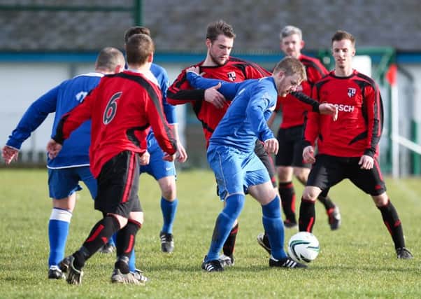 Midfield action from Kilroot Rec v Mossley FC. Photo: Ronnie Moore