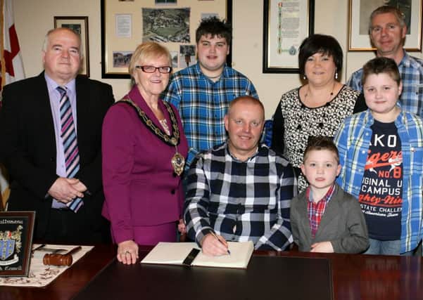 Trevor Stirling, who recently received a fifth place finish in the World Roads Associations snow plough championships in  Andorra, is pictured at a special reception with the Mayor of Ballymena, Cllr. Audrey Wales, to mark the achievement. Trevor is pictured with his wife Martina, children Sam, Jack and Harry, and work colleague Alan McLeister, and Cllr. Martin Clarke. INBT09-203AC