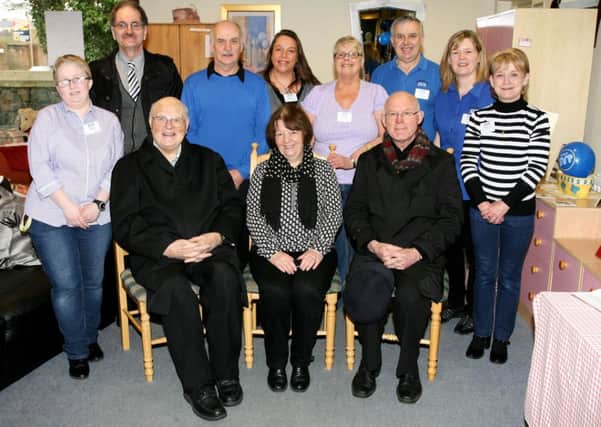 Archdeacon Donnolly, Mary Waide (area President) and Fr. P. Delargy with staff and volunteers of the St. Vincent de Paul shop celebrating its 5th anniversary. INBT09-209AC