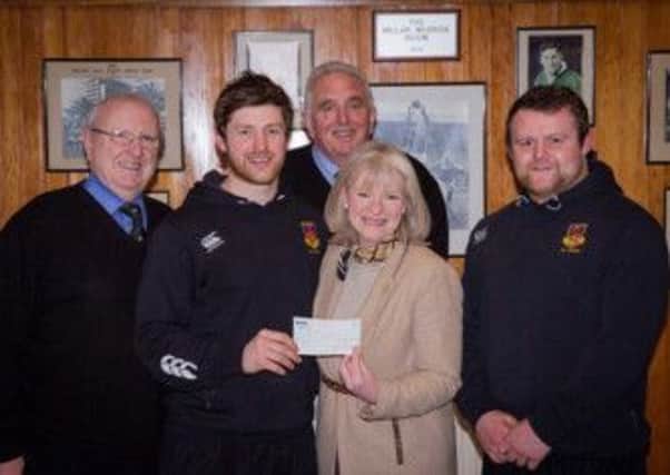 Gillian Creevy, Chief Executive of the Northern Ireland Cancer Fund for Children receives a cheque for £500 from Ballymena Rugby Club First tXV captain, Martin Irwin. Also in the picture are Bill Wallace, Chairman, Tom Wiggins (Vice Chairman) and Andrew Warwick (Vice Captain).  The money was raised at a function run by club members earlier in the season.