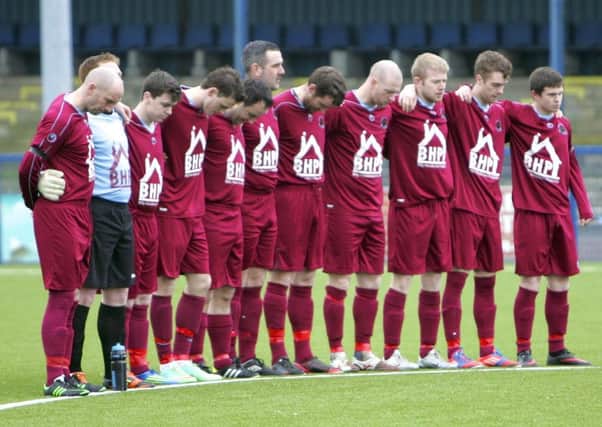 Institute players pictured during a minute silence for life-long fan Ronnie White before Saturday's game at Bangor. Mr White had a long battle with motor neurons disease and everyone's thoughts at Institute FC are with his family at this sad time.