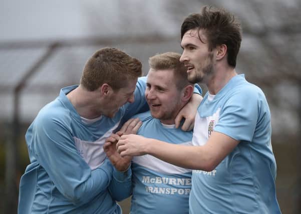Ballymena United's David Cushley celebrates with team-mates Darren Boyce and Michael McLellan after opening the scoring against Warrenpoint on Saturday. Picture: Press Eye.