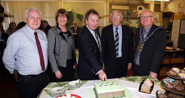 Mr Kirker, head of Technology and Design, principal Jacqueline Stewart, Danny Kinahan MLA, Rey Kirk of the North Irish Horse Regiment and the Mayor of Carrick, Alderman Billy Ashe, cutting the tank themed cake. INCT 09-755-CON